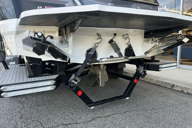 Slide: The Image of 2018 MasterCraft XT22 boat rear view with advanced wakeboard features. - 14