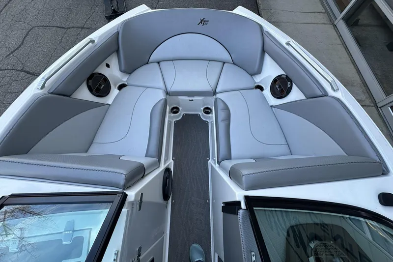 Slide: The Image of 2018 MasterCraft XT22 boat interior with gray seating and speakers. - 3