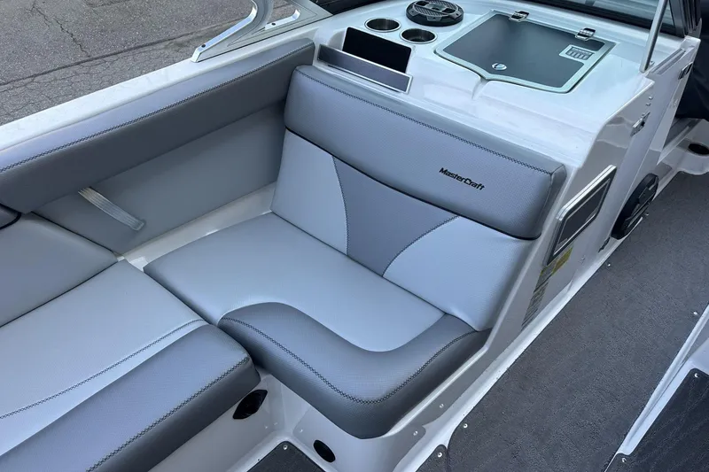 Slide: The Image of 2018 MasterCraft XT22 boat interior with gray seating and dashboard details. - 6