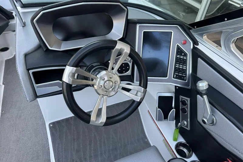 Slide: The Image of 2018 MasterCraft XT22 boat dashboard with steering wheel and control panel. - 7