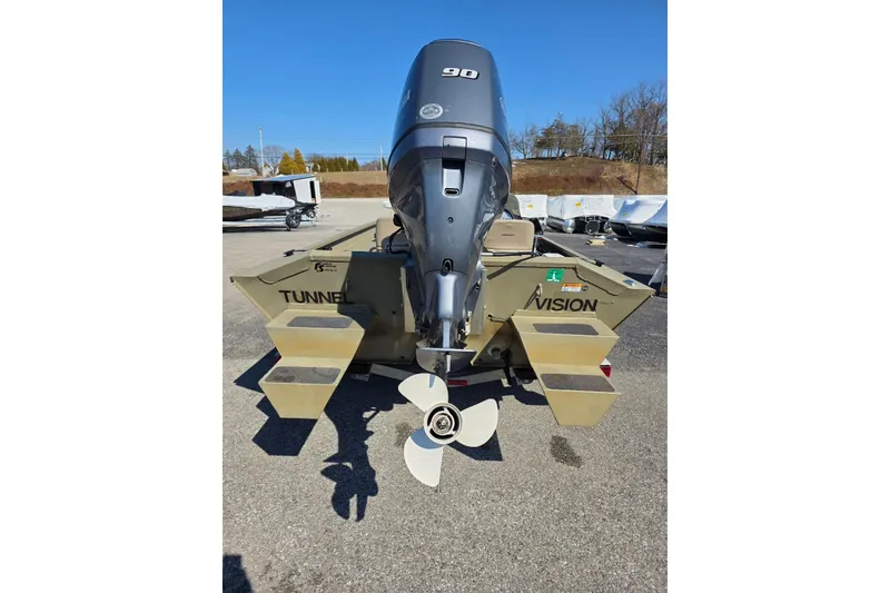 Slide: The Image of 2011 Alumacraft MV 1860 AW SC boat with outboard motor, parked on pavement. - 10