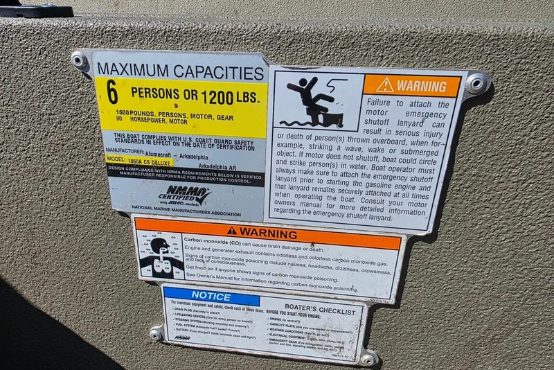 Slide: The Image of 2011 Alumacraft MV 1860 AW SC capacity and safety warning labels on boat interior. - 22