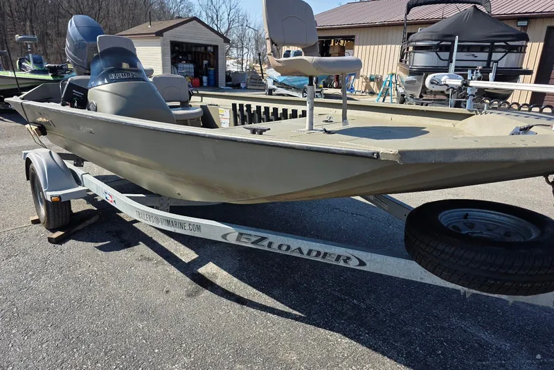 Slide: The Image of 2011 Alumacraft MV 1860 AW SC boat on EZ Loader trailer, parked outdoors. - 5
