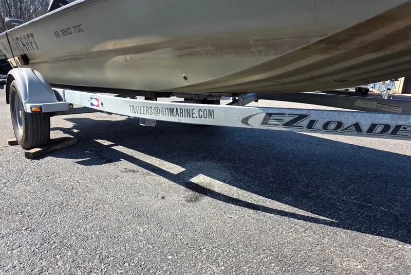 Slide: The Image of 2011 Alumacraft MV 1860 AW SC boat on EZ Loader trailer in parking lot. - 7