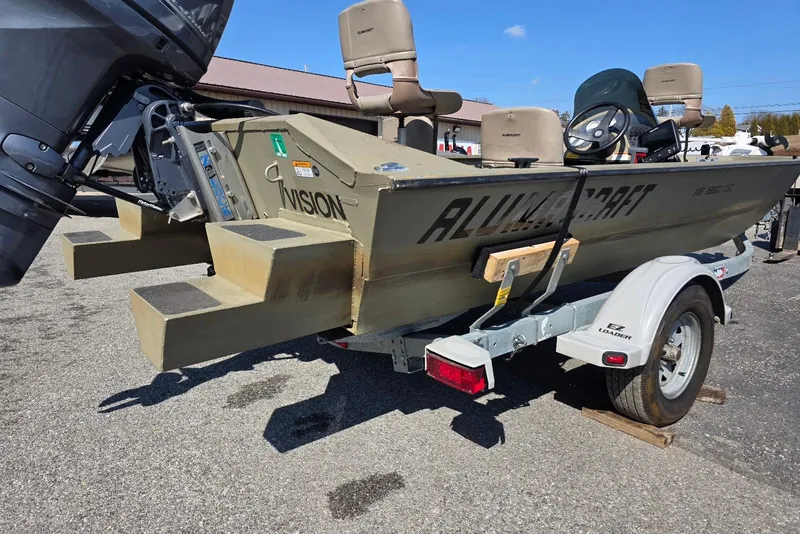 Slide: The Image of 2011 Alumacraft MV 1860 AW SC boat on trailer, featuring outboard motor and seating. - 8