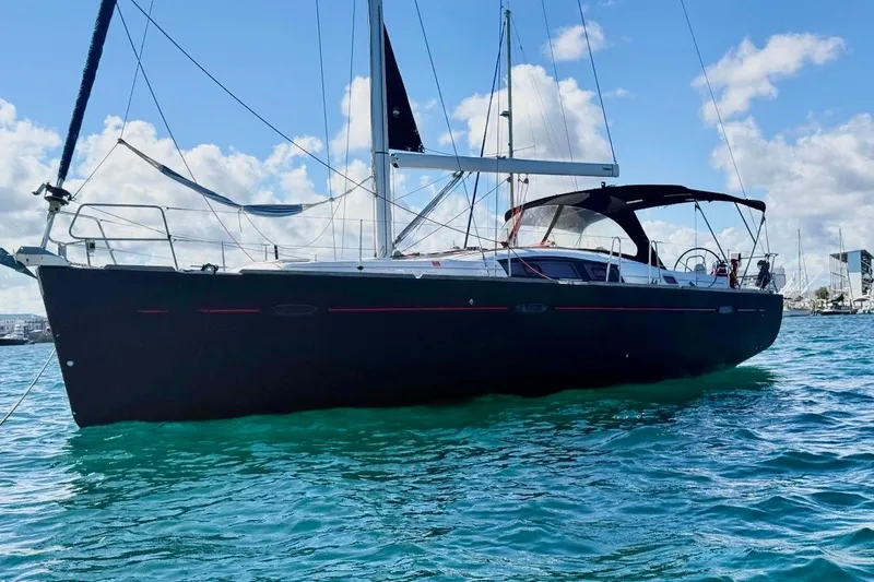 The Image of 2009 Beneteau Oceanis 43 sailboat on clear blue water under a sunny sky. - 0