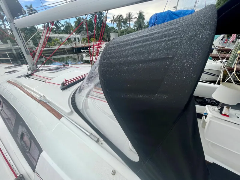 Slide: The Image of Beneteau Oceanis 43 sailboat, 2009 model, with black canopy in harbor. - 15