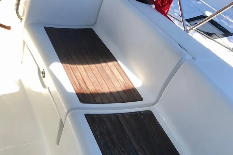 Slide: The Image of Beneteau Oceanis 43 (2009) cockpit with wooden seating and white fiberglass finish. - 44