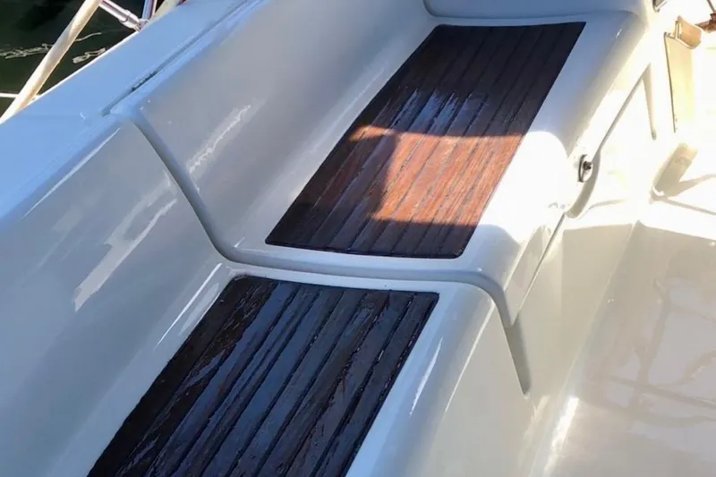 Slide: The Image of Beneteau Oceanis 43 (2009) cockpit with wooden seating and sleek white finish. - 45