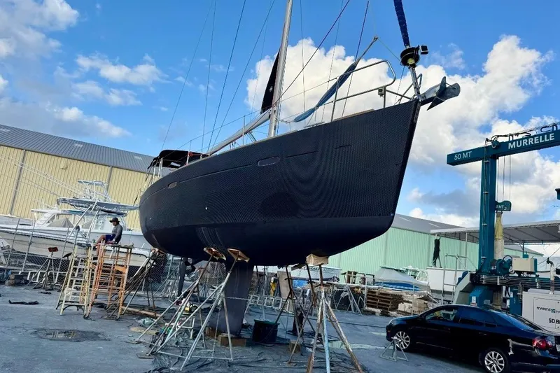 Slide: The Image of 2009 Beneteau Oceanis 43 sailboat in dry dock, undergoing maintenance under a blue sky. - 5