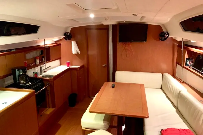 Slide: The Image of Interior of 2009 Beneteau Oceanis 43 yacht with cozy seating and modern kitchen amenities. - 93