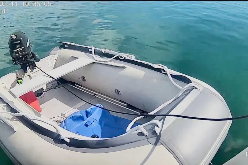 Slide: The Image of Inflatable dinghy with outboard motor on clear water, associated with 2009 Beneteau Oceanis 43. - 94