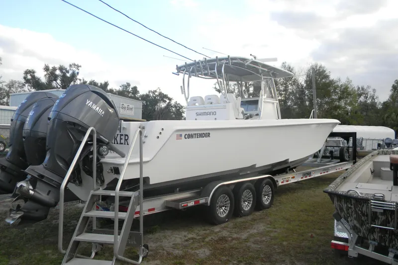 The Image of 2022 Contender 39 ST boat on trailer with Yamaha engines, parked outdoors. - 0