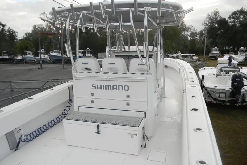 Slide: The Image of 2022 Contender 39 ST boat with Shimano branding, docked in a marina. - 11