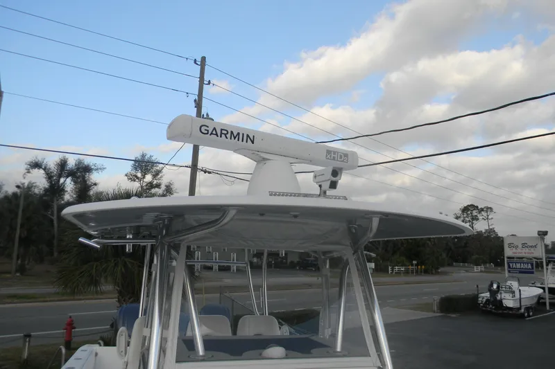 Slide: The Image of 2022 Contender 39 ST boat with Garmin radar, parked near a Yamaha dealership. - 12