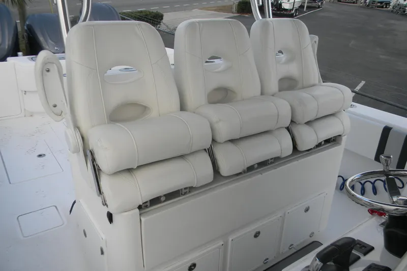 Slide: The Image of 2022 Contender 39 ST boat with three white cushioned seats and steering wheel. - 4