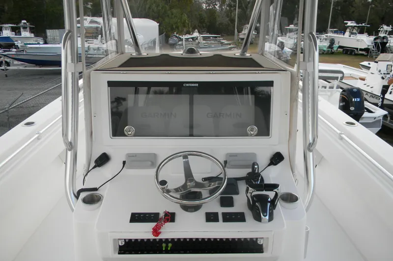 Slide: The Image of 2022 Contender 39 ST boat dashboard with Garmin navigation system and steering wheel. - 7