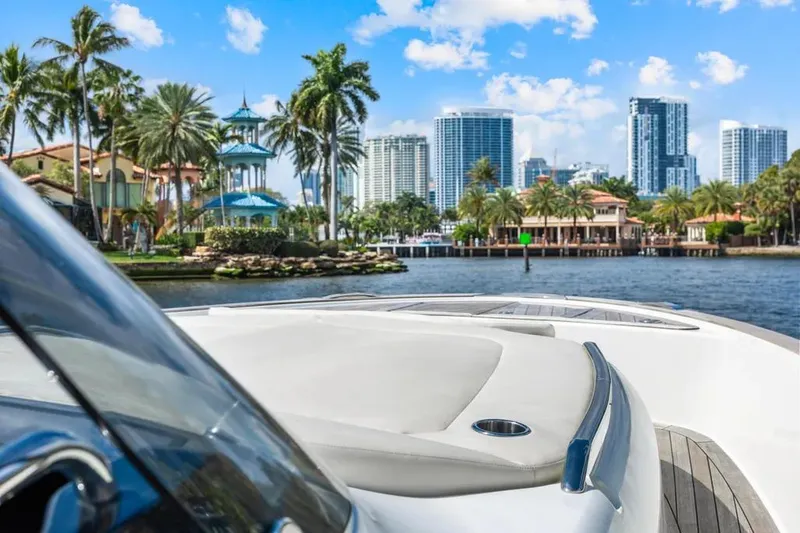 Slide: The Image of 2024 Solaris Power 44 Open yacht cruising near city skyline and palm trees. - 15