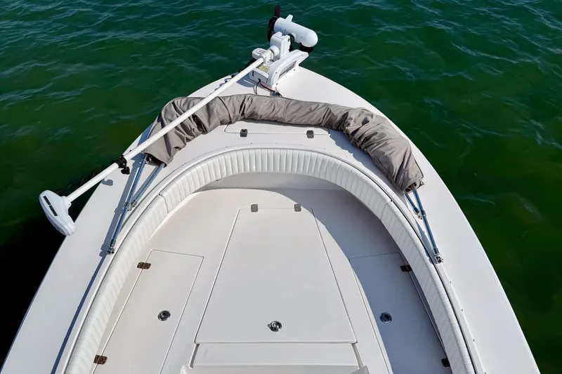 Slide: The Image of 2019 Aquasport 244 Bay boat bow with cushioned seating on calm water. - 10