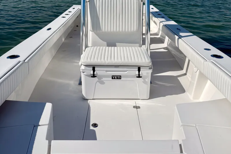 Slide: The Image of 2019 Aquasport 244 Bay boat interior with Yeti cooler seat, on calm water. - 15