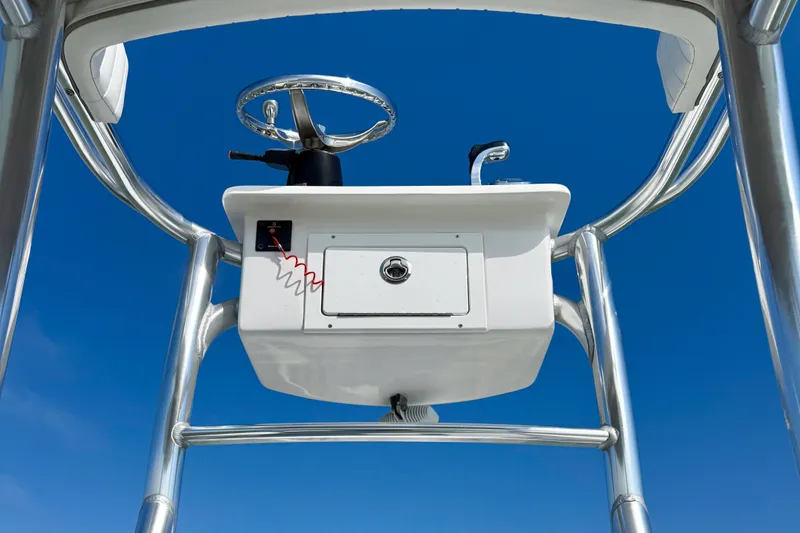 Slide: The Image of 2019 Aquasport 244 Bay boat console against clear blue sky. - 18