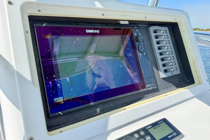 Slide: The Image of Simrad navigation system on 2019 Aquasport 244 Bay boat dashboard. - 22