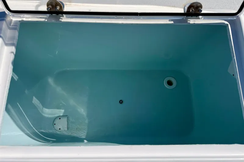 Slide: The Image of Open storage compartment in 2019 Aquasport 244 Bay boat, featuring a clean, spacious interior. - 30