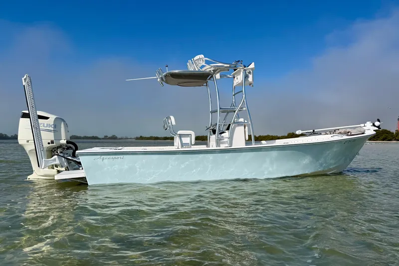 Slide: The Image of 2019 Aquasport 244 Bay boat on calm water with Suzuki outboard motor. - 5