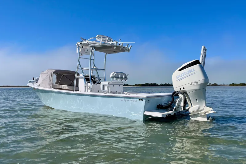 Slide: The Image of 2019 Aquasport 244 Bay boat with Suzuki engine on calm water. - 6