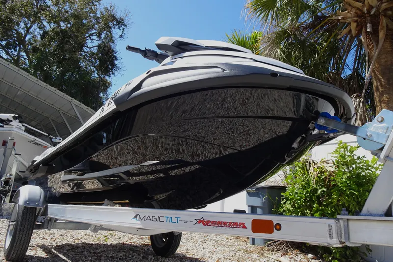 Slide: The Image of 2024 Yamaha WaveRunner VX Cruiser on trailer, parked outdoors under trees. - 4
