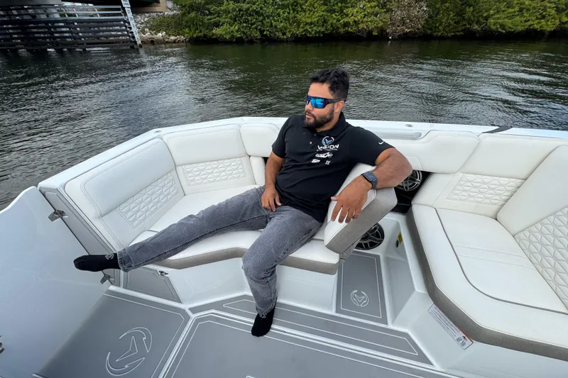 Slide: The Image of Man relaxing on 2026 Ingenity EL boat, wearing sunglasses, near water. - 17