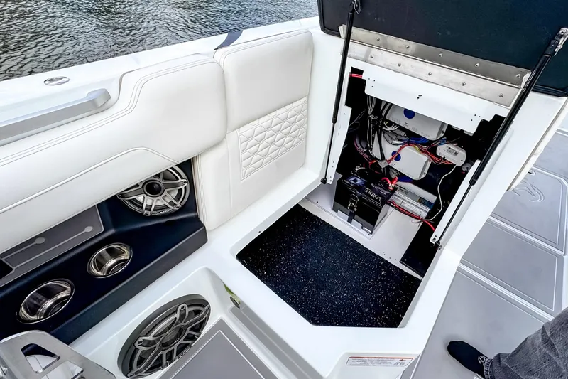 Slide: The Image of 2026 Ingenity EL boat interior showing open compartment with wiring and speakers. - 19
