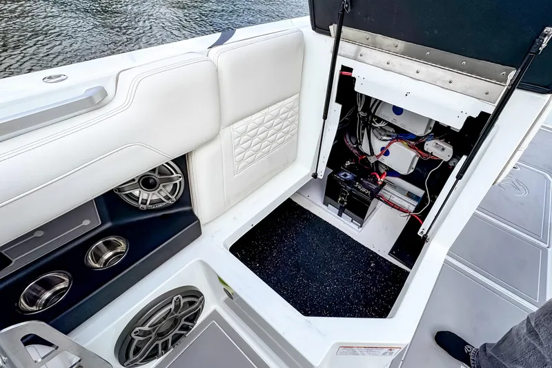 Slide: The Image of 2026 Ingenity EL boat interior showing open compartment with wiring and speakers. - 20