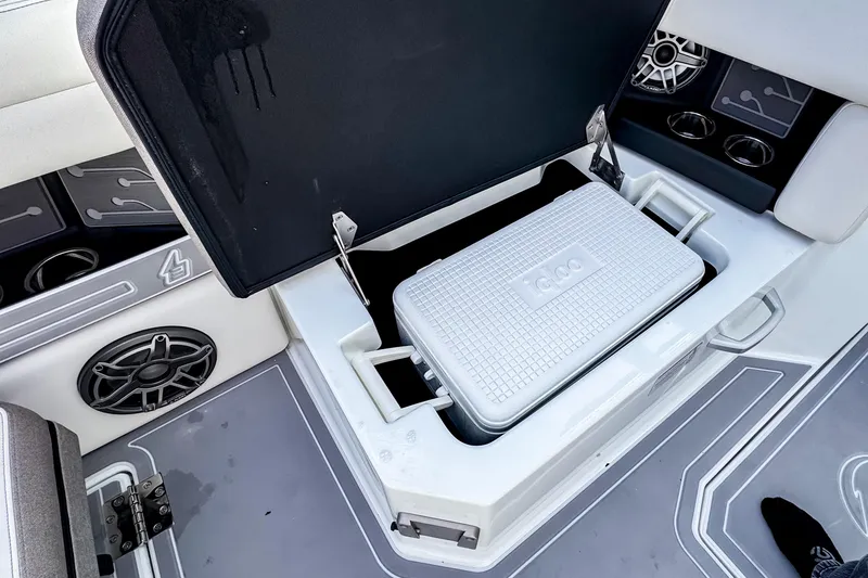 Slide: The Image of Open storage compartment on 2026 Ingenity EL boat with cooler inside. - 24