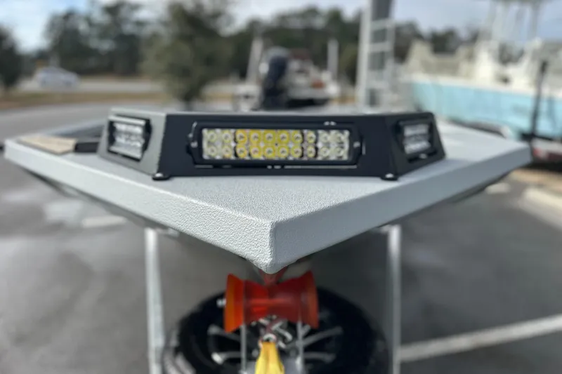 Slide: The Image of 2026 Avid 18 Commander boat with LED lights on the bow, parked outdoors. - 10