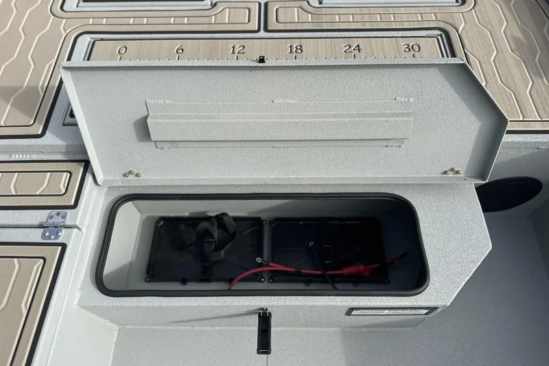 Slide: The Image of Open storage compartment on 2026 Avid 18 Commander boat deck. - 18