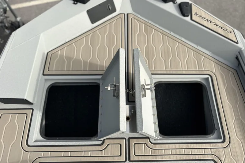 Slide: The Image of 2026 Avid 18 Commander boat storage compartments with open hatches, showcasing modern design. - 20
