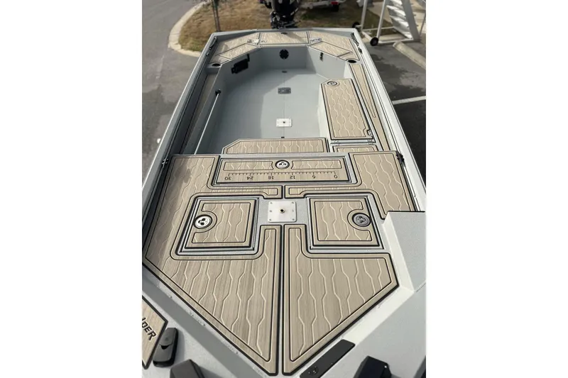 Slide: The Image of 2026 Avid 18 Commander boat interior with tan deck and storage compartments. - 21