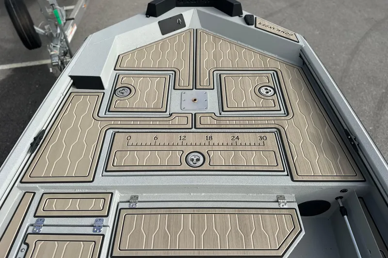 Slide: The Image of 2026 Avid 18 Commander boat deck with textured design and measurement markings. - 24