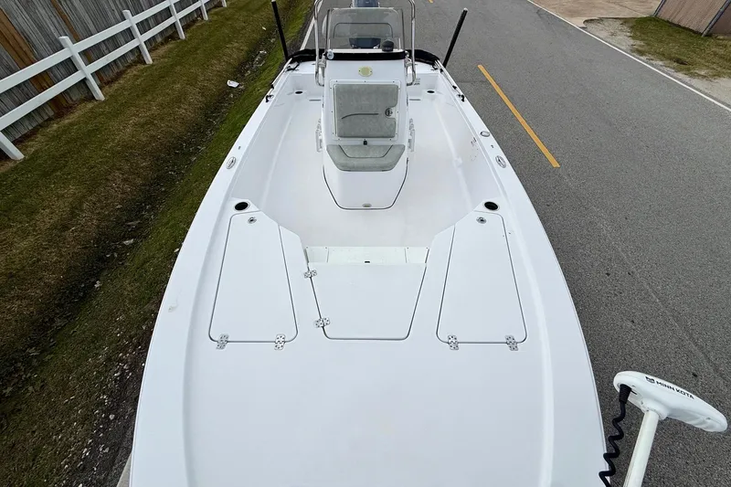 Slide: The Image of 2020 Sportsman Tournament 214 SBX Bay Boat on road, top view, white deck, trolling motor. - 15