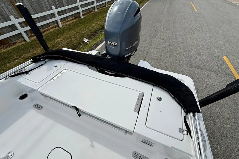 Slide: The Image of 2020 Sportsman Tournament 214 SBX Bay Boat with Yamaha 150 engine on a road. - 8