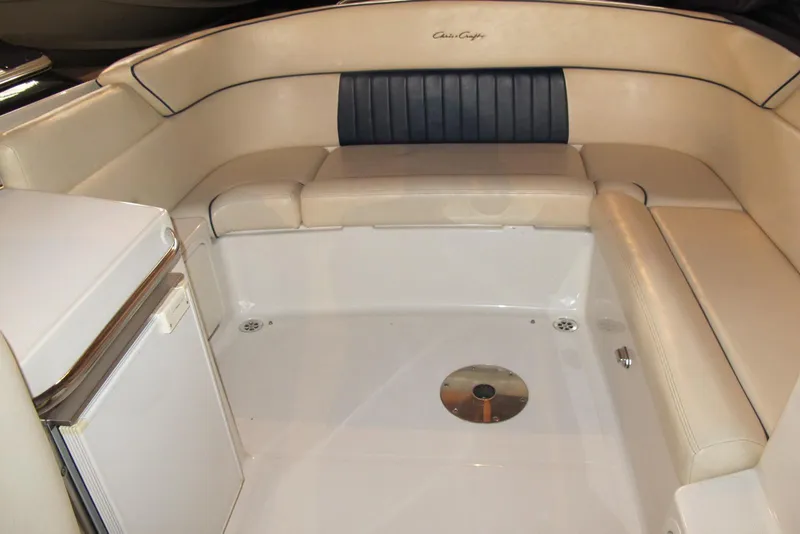 Slide: The Image of 2003 Chris-Craft Corsair 25 Heritage Edition boat interior with beige seating and mini fridge. - 6