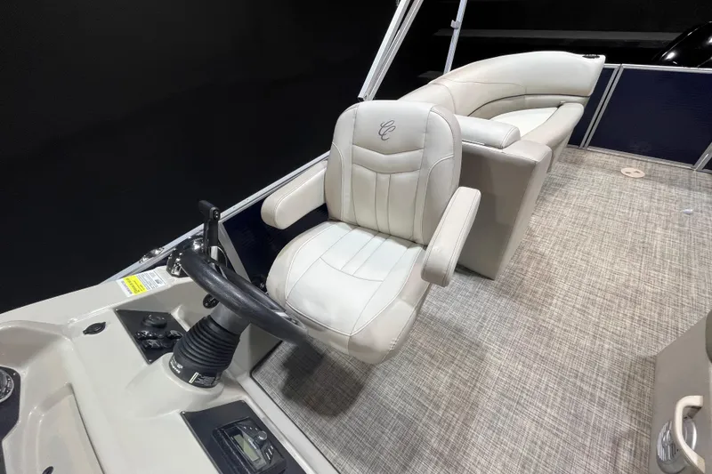 Slide: The Image of 2023 Cypress Cay Seabreeze 232 boat interior with captain's chair and steering console. - 10