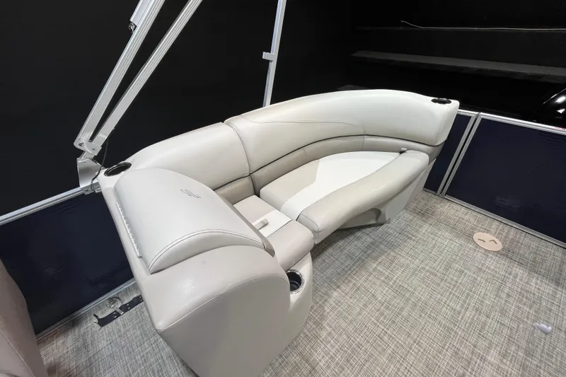 Slide: The Image of 2023 Cypress Cay Seabreeze 232 boat interior with plush seating and cup holders. - 12
