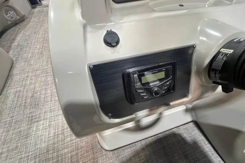 Slide: The Image of 2023 Cypress Cay Seabreeze 232 boat dashboard with media center and control panel. - 14