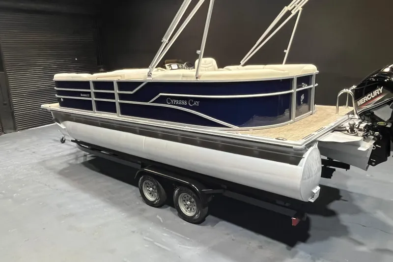 Slide: The Image of 2023 Cypress Cay Seabreeze 232 pontoon boat on trailer, featuring Mercury outboard motor. - 4