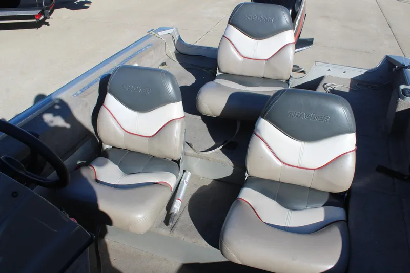 Slide: The Image of 2004 Tracker Pro Angler V 16 boat interior with three cushioned seats. - 10