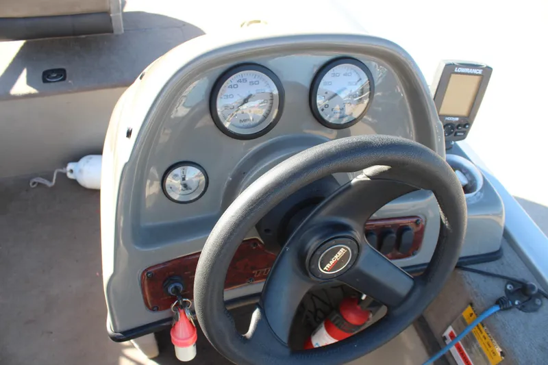 Slide: The Image of 2004 Tracker Pro Angler V 16 boat dashboard with steering wheel and gauges. - 11