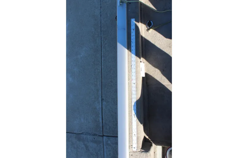 Slide: The Image of Ruler on 2004 Tracker Pro Angler V 16 boat deck, measuring surface length. - 17