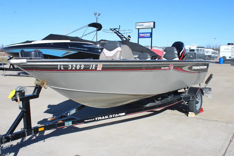 Slide: The Image of 2004 Tracker Pro Angler V 16 boat on a trailer in a dealership lot. - 3